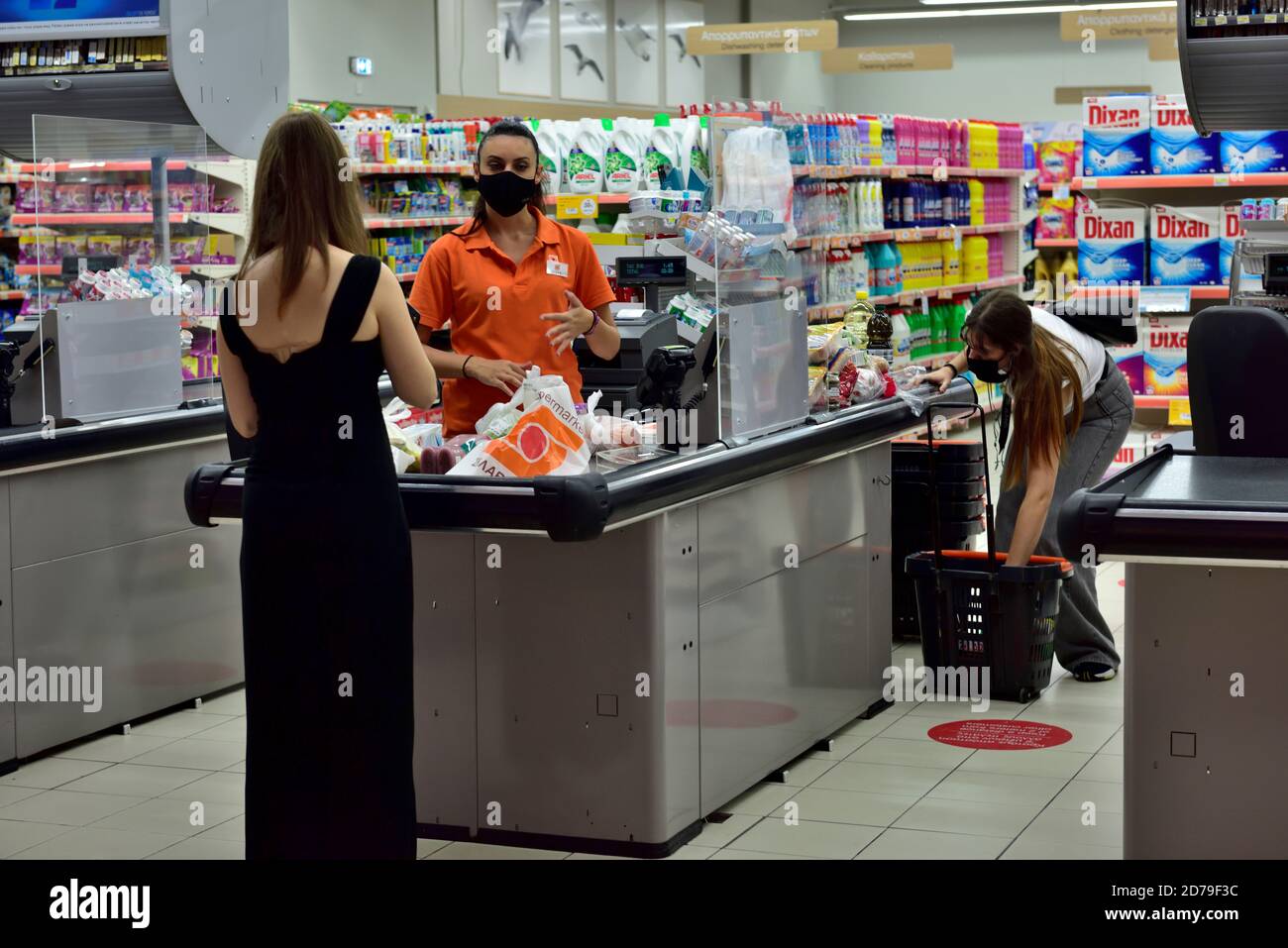 Supermarket ( S?????????S) checkout till with people wearing face masks for covid protection, inside large shopping mall,  “Kings Avenue”, Paphos, Cyp Stock Photo