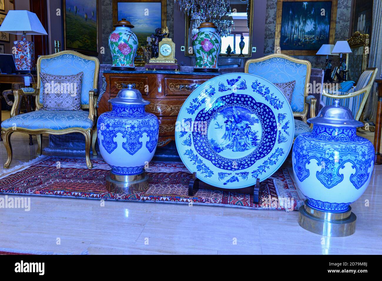 Various antique clocks vases and candlesticks on display. Stock Photo