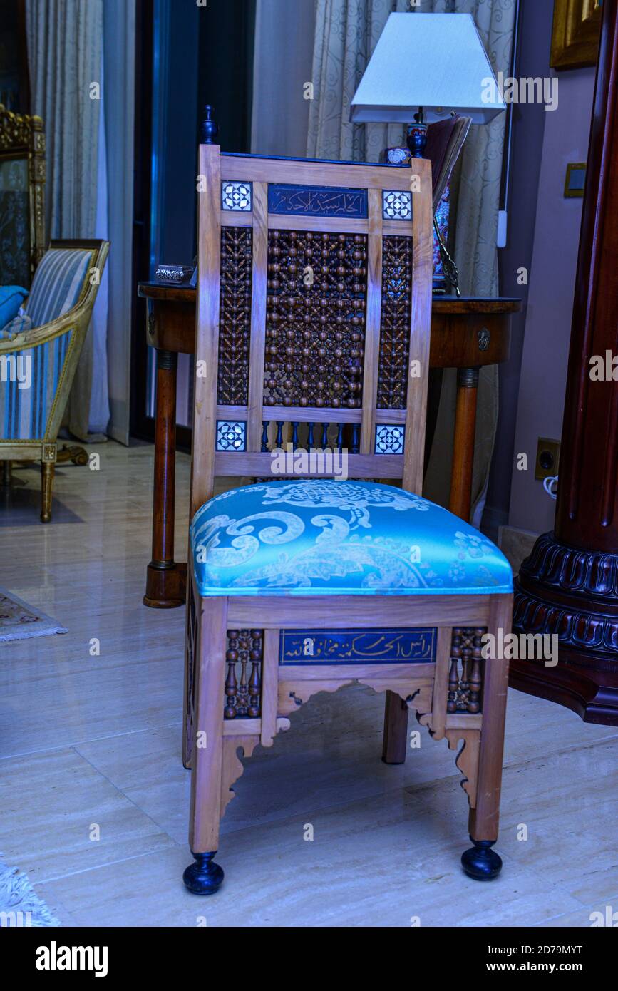 An old Arabic chair made of original wood, wrapped in blue fabric Stock