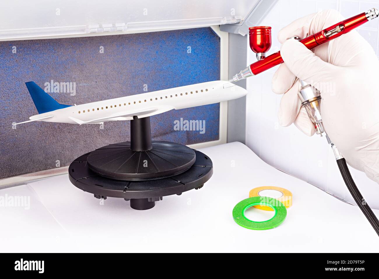 paint job with red metal airbrush spray paint gun on red scale model on