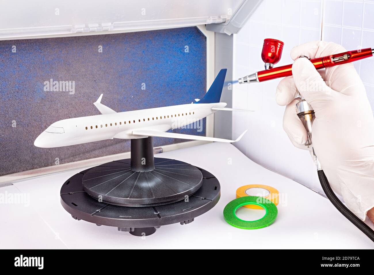 paint job with red metal airbrush spray paint gun on red scale model on