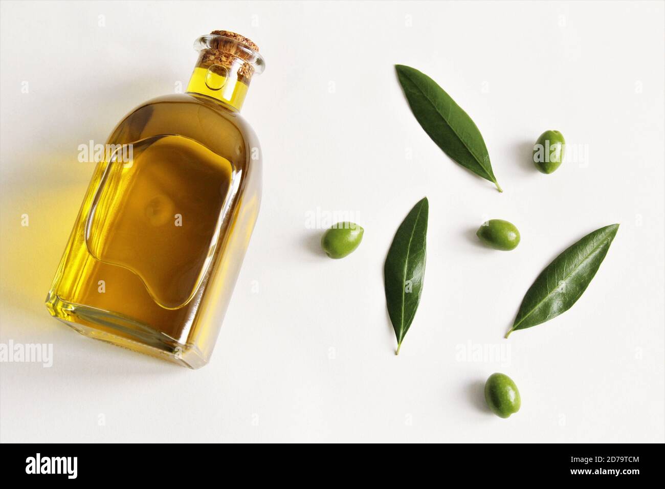 Olive oil glass bottle with green olives and olive leave photo isolate ...
