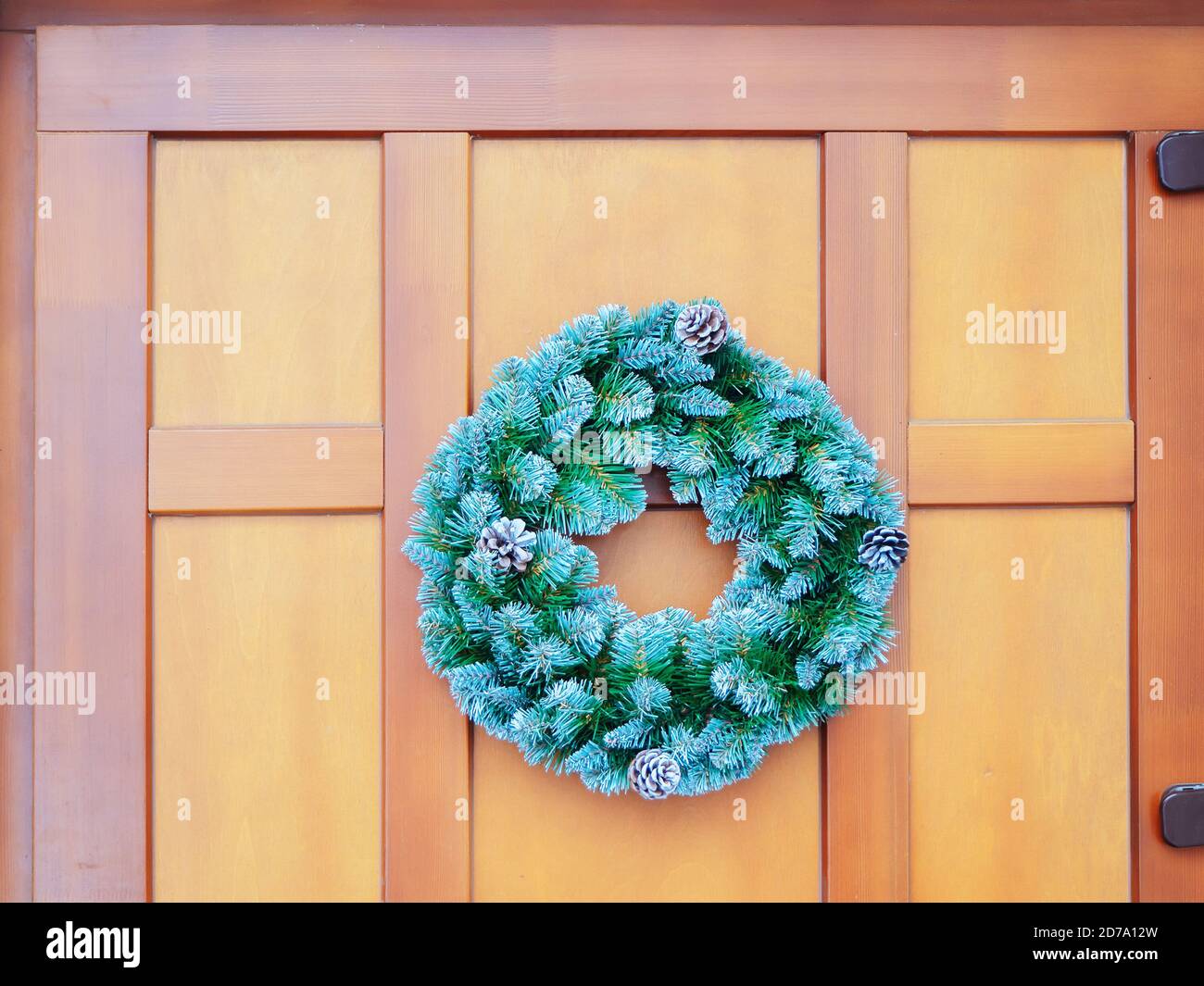 Christmas fir wreath with pine cones hanging on a wooden door Stock ...