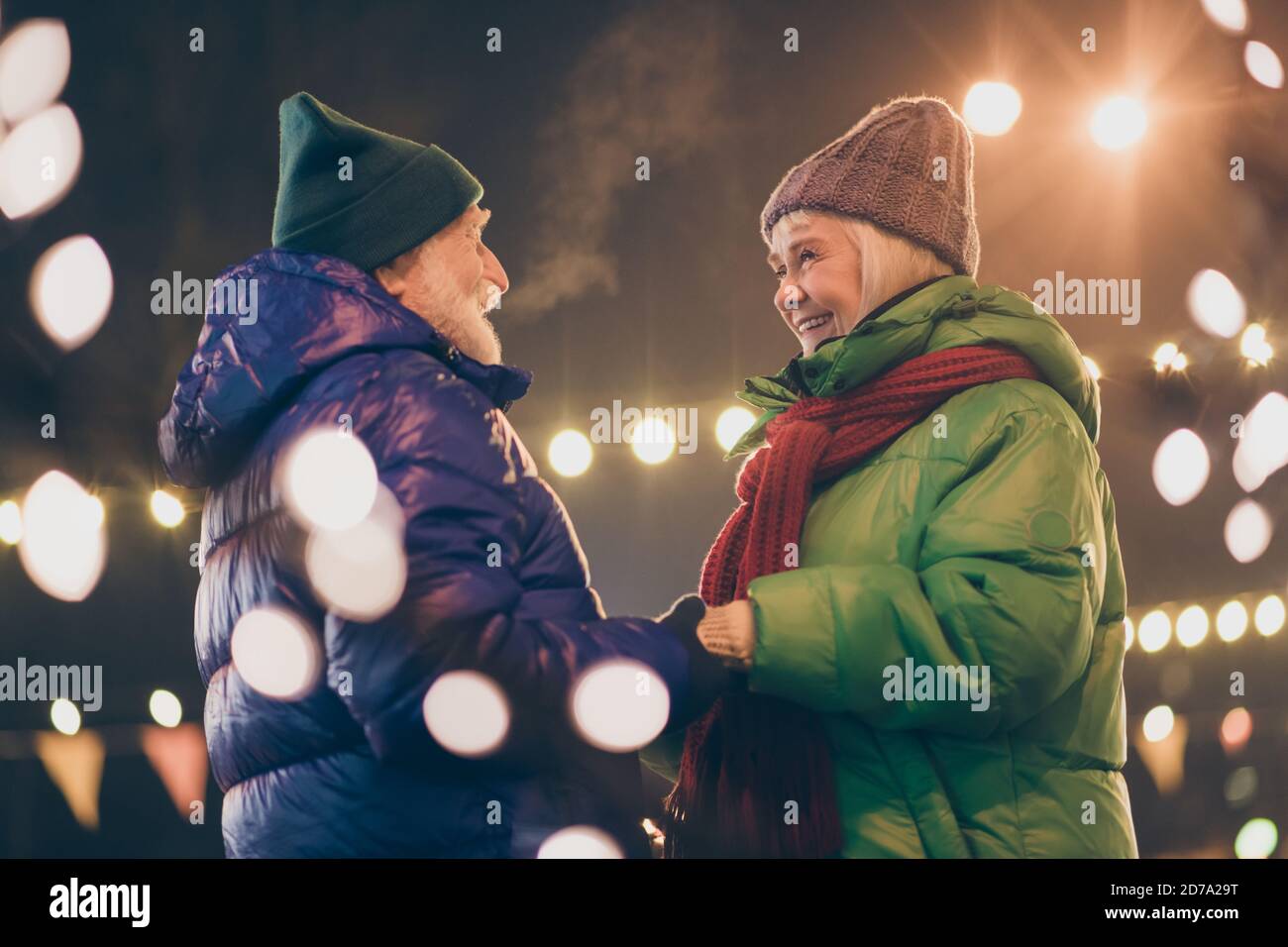 Photo of two people pensioner lovers friends hold hands grandpa tell  grandma soft speech making her happy wear mittens coat red scarf headwear  x-mas Stock Photo - Alamy