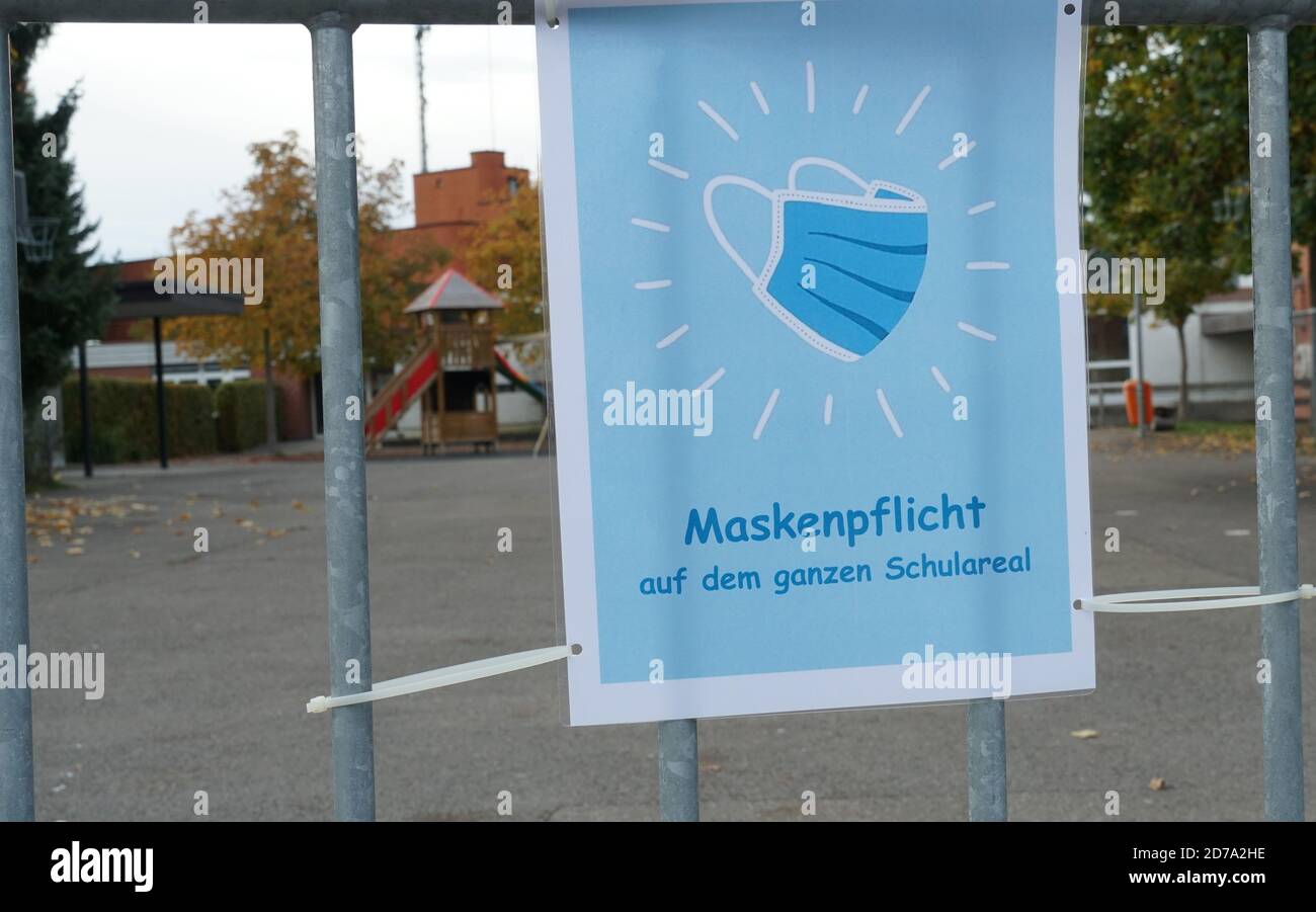 A sign poster in German language saying a face mask is obligatory on school ground. A new normal in a village Urdorf in Switzerland in the second wave. Stock Photo
