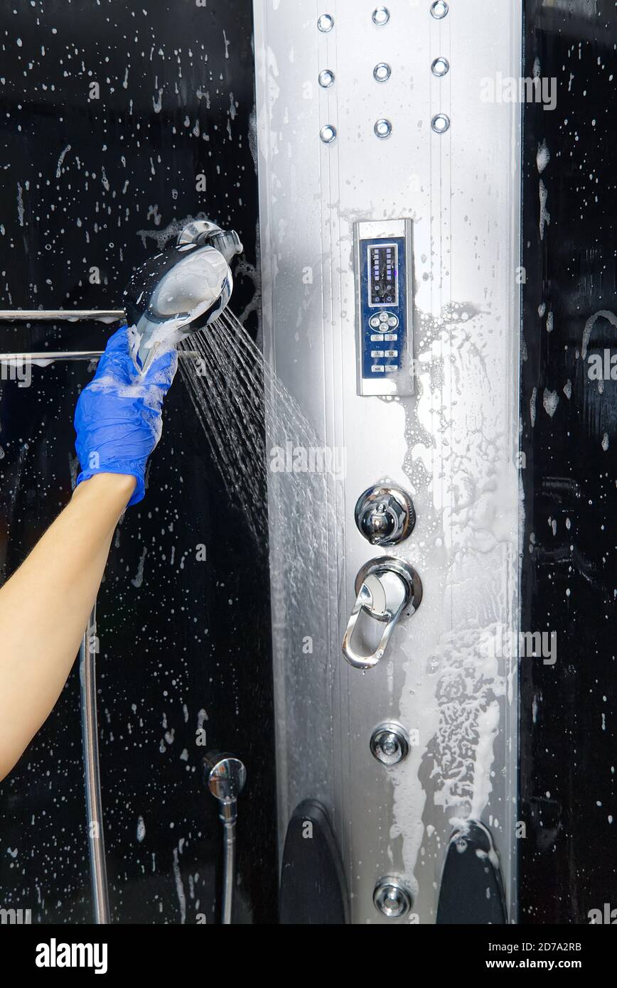 Cleaning of shower steam cabins from calcium deposits. Cleaning in the