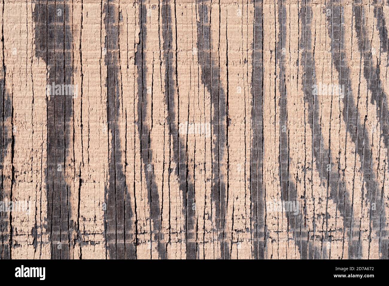 The surface of old exterior plywood with very faded paint showing wood and wear from weather. Stock Photo