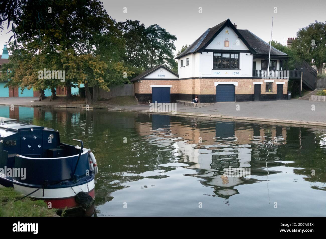 View with narrowboat, Peterhouse Boathouse and rowing club overlooking River Cam, Cambridge England Stock Photo