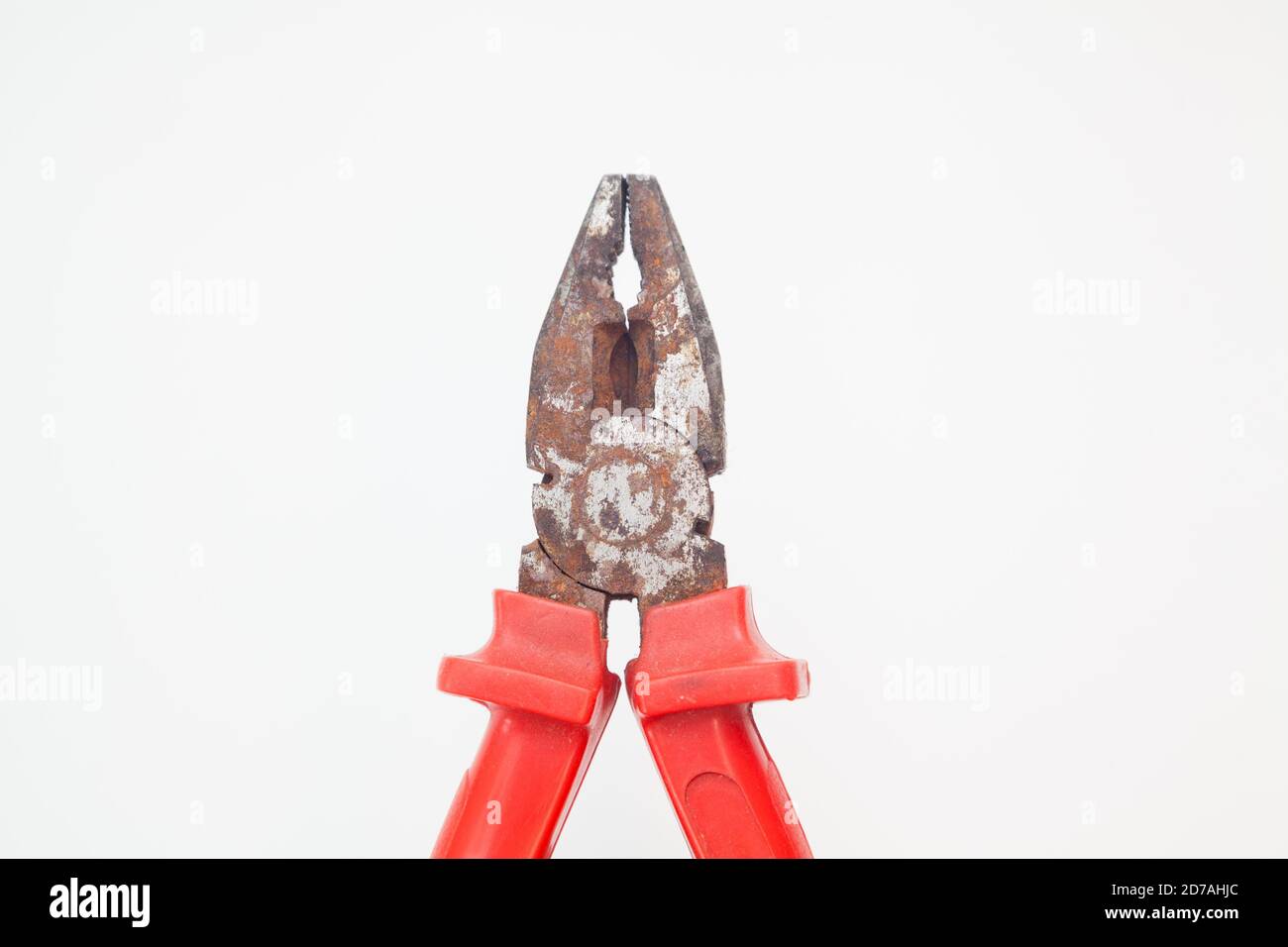 closed rusty red pliers against white background Stock Photo Alamy