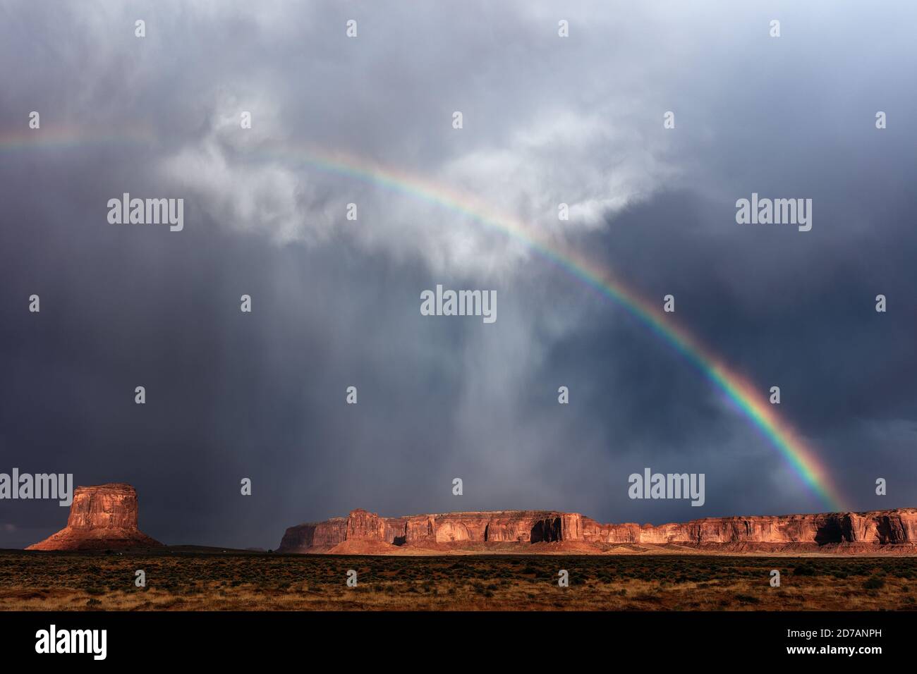 Scenic landscape with a storm and rainbow over Monument Valley, Arizona, USA Stock Photo