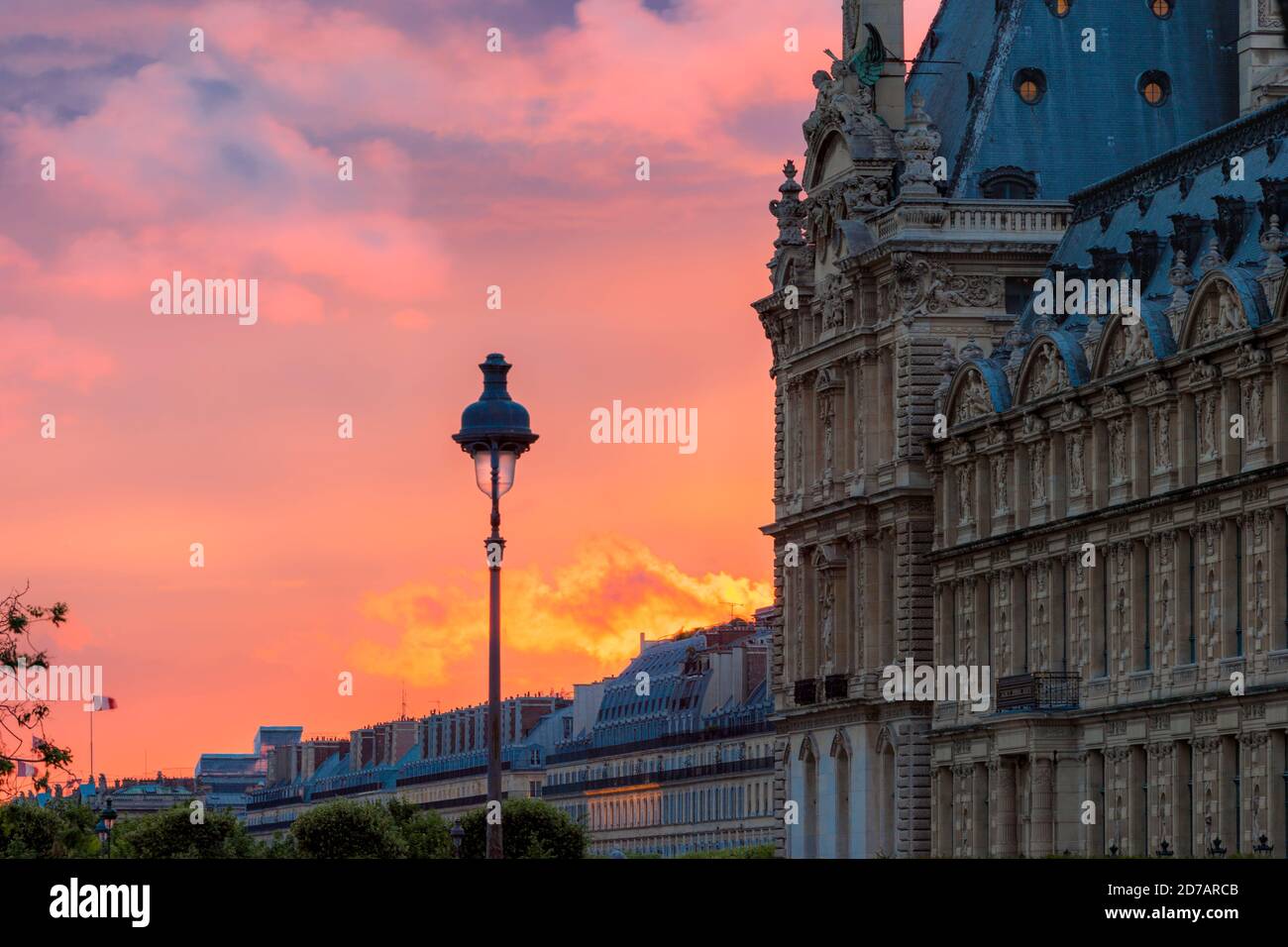 Colorful sunset behind the classic French architecture of Musse du Louvre, Paris, France Stock Photo