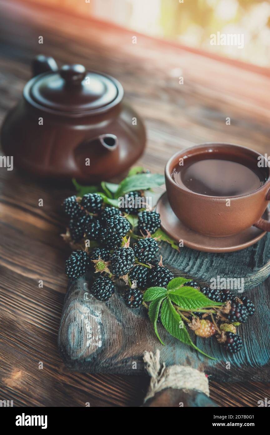 Fruit tea in a Cup with blackberries. Tea is made from berries and