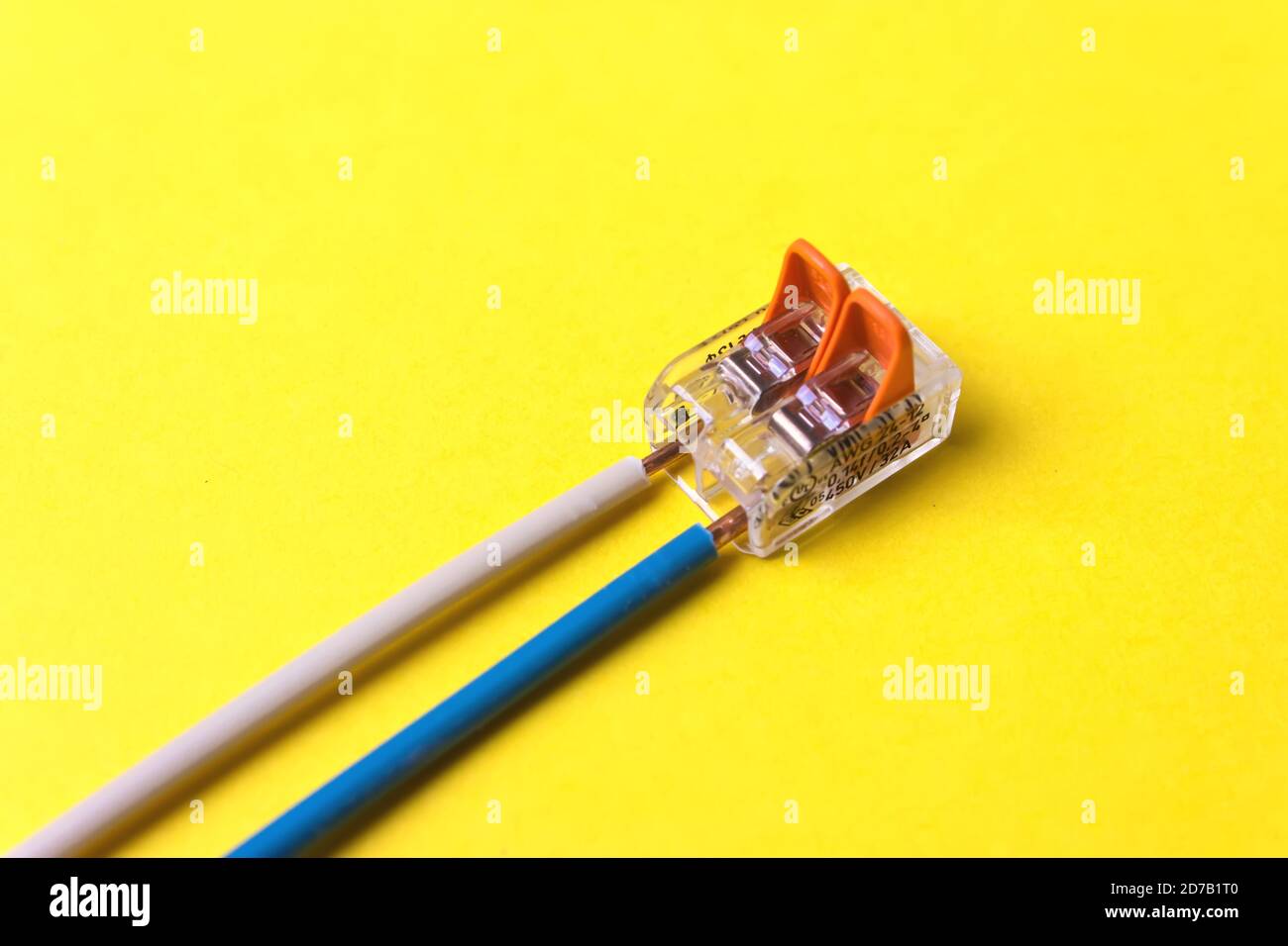 Compact orange splicing connector with two wires phase, zero. Connection concept Stock Photo