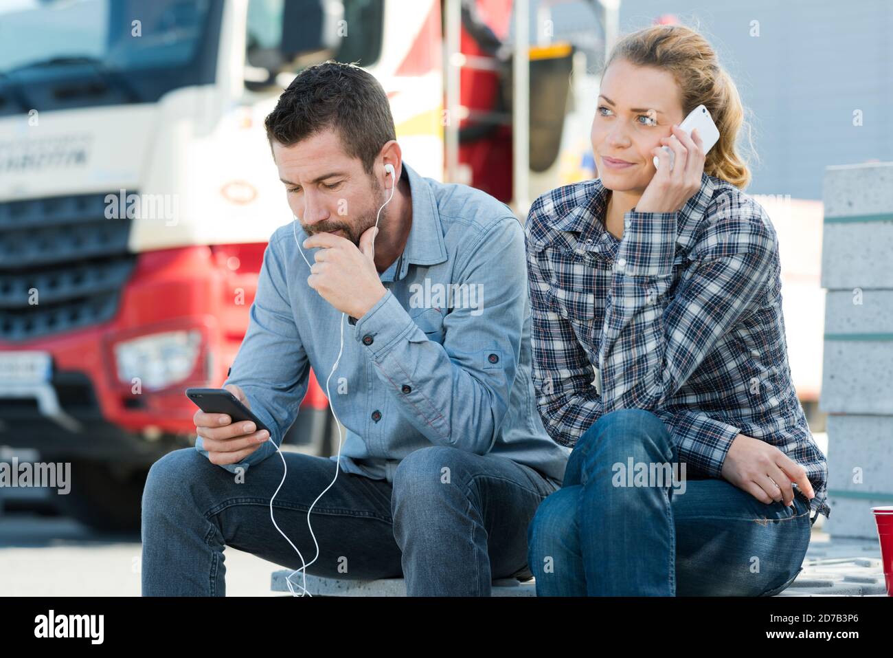 workers listening to music outdoors Stock Photo