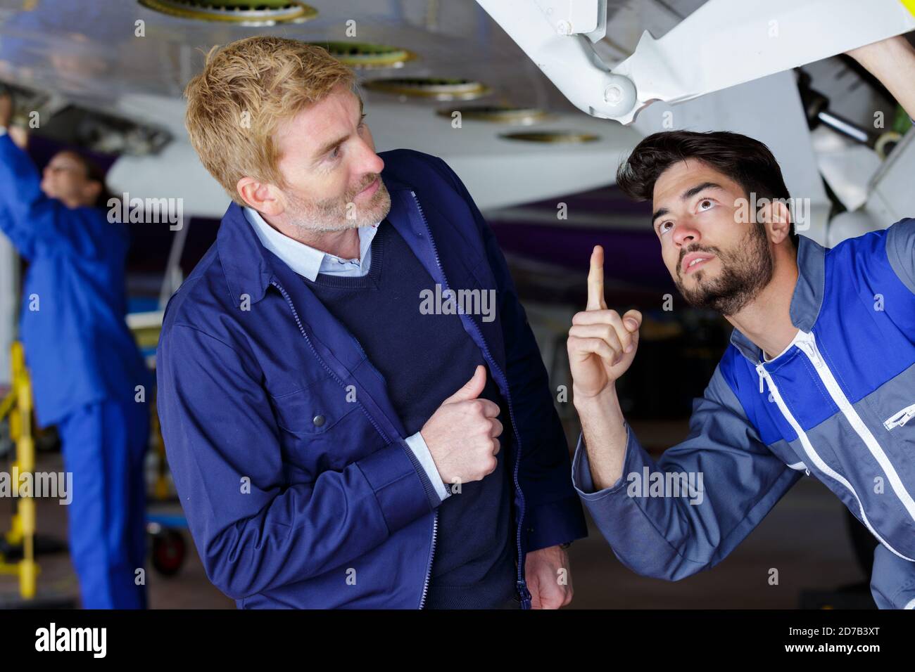 an airport worker checking chassis Stock Photo