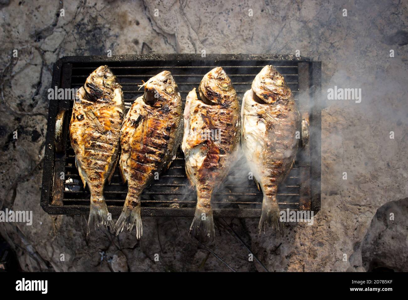 Fish on the grill with smoke Stock Photo Alamy