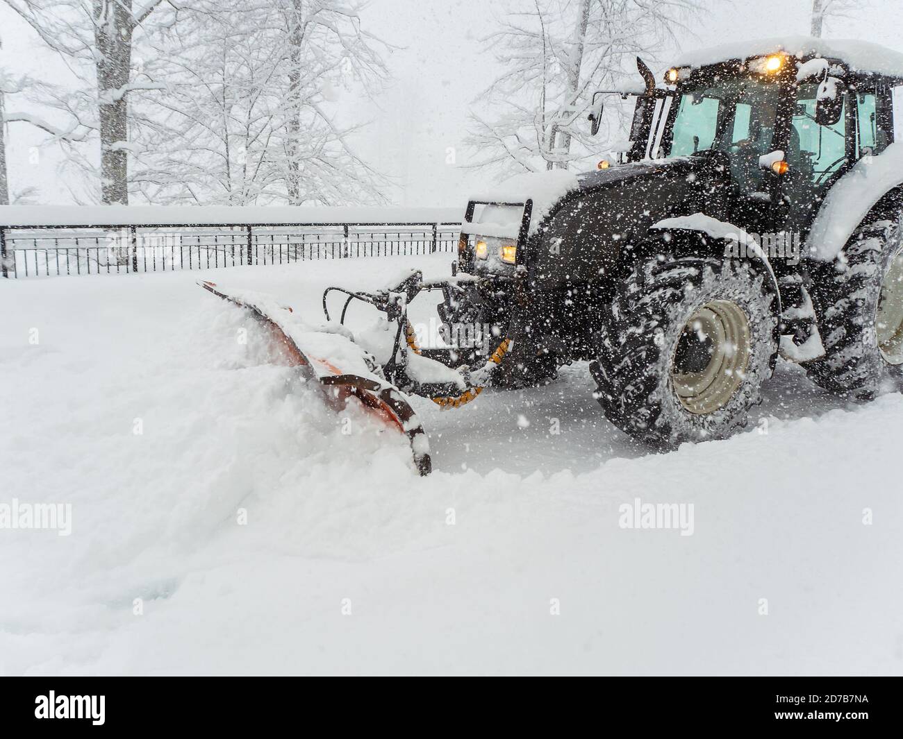 Snow plow tractor clears snowy road during heavy blizzard Stock Photo Alamy