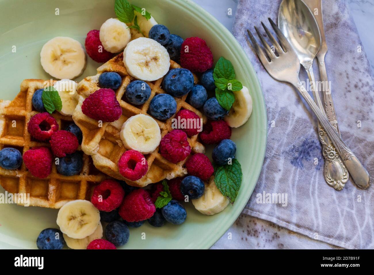 waffles, blueberries, raspberries, bananas and mint. Stock Photo