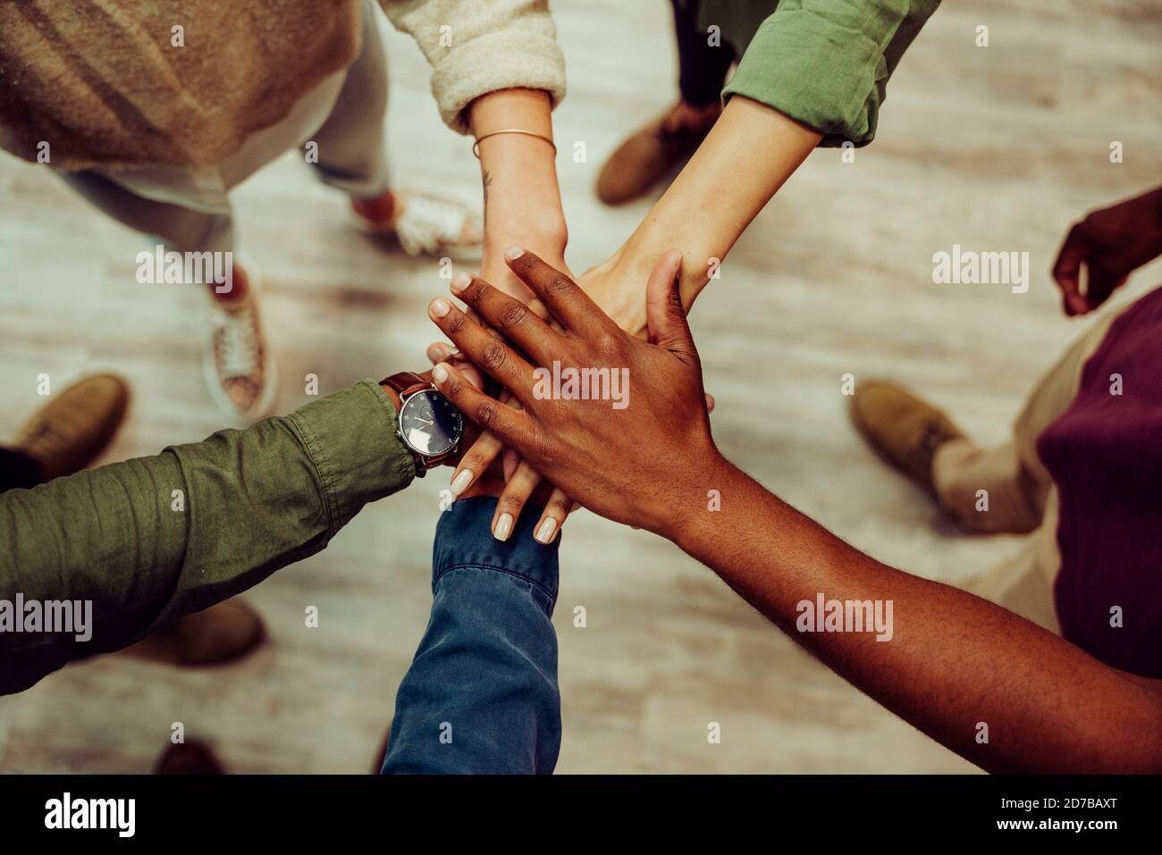 Successful business group hands stacked together showing unity and team work. Stock Photo