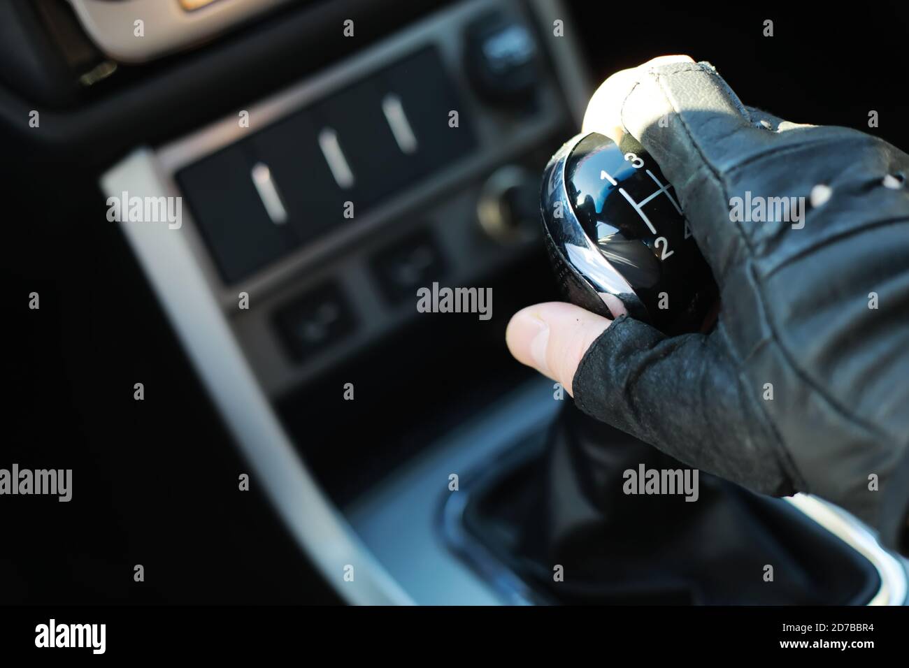 Gear lever. Manual Transmission. Hand on the gear shift in a car Stock