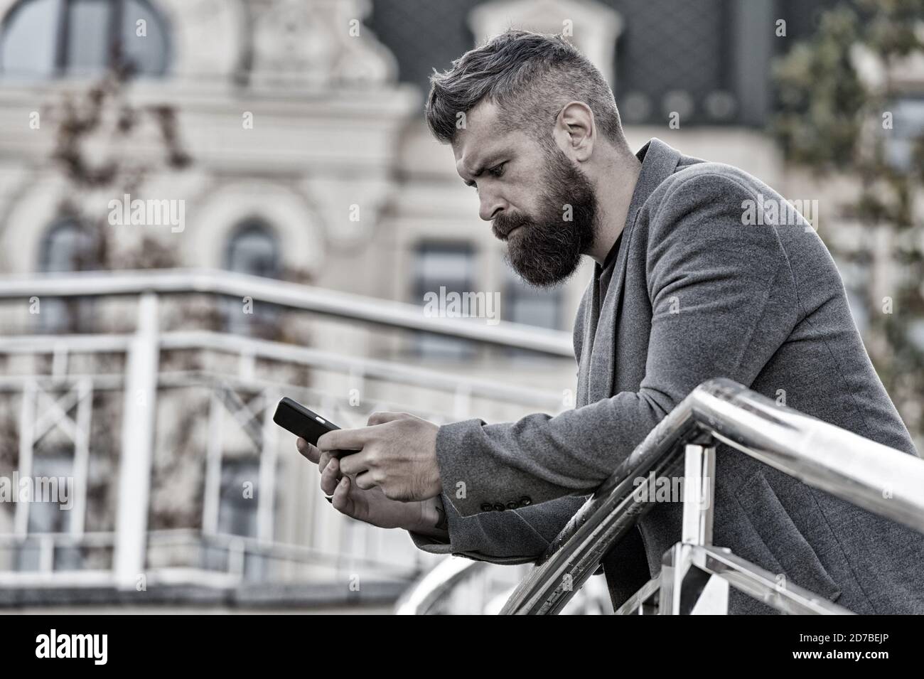 Blogging for business. Man blogger outdoor. Businessman keep business blog. Bearded man read blog post. Follow marketing blog. Real time live blog. New technology. Stock Photo