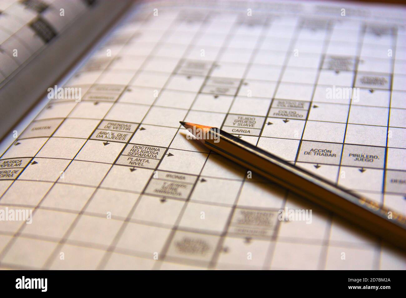 Image with copy space of a pencil on a crossword in Spanish that is unfinished Stock Photo