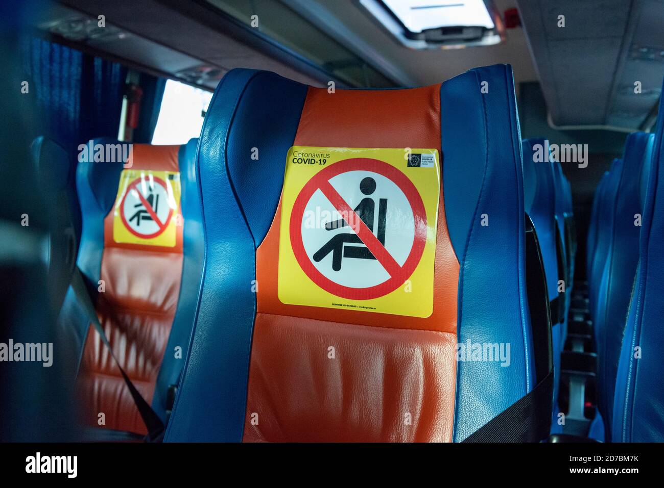 Social distancing yellow sign on seat inside bus during the pandemic outbreak of Coronavirus Covid 19 in Ireland, Europe Stock Photo