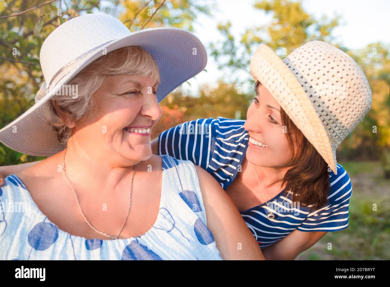 Happy daughter embracing her smiling mother. Stock Photo