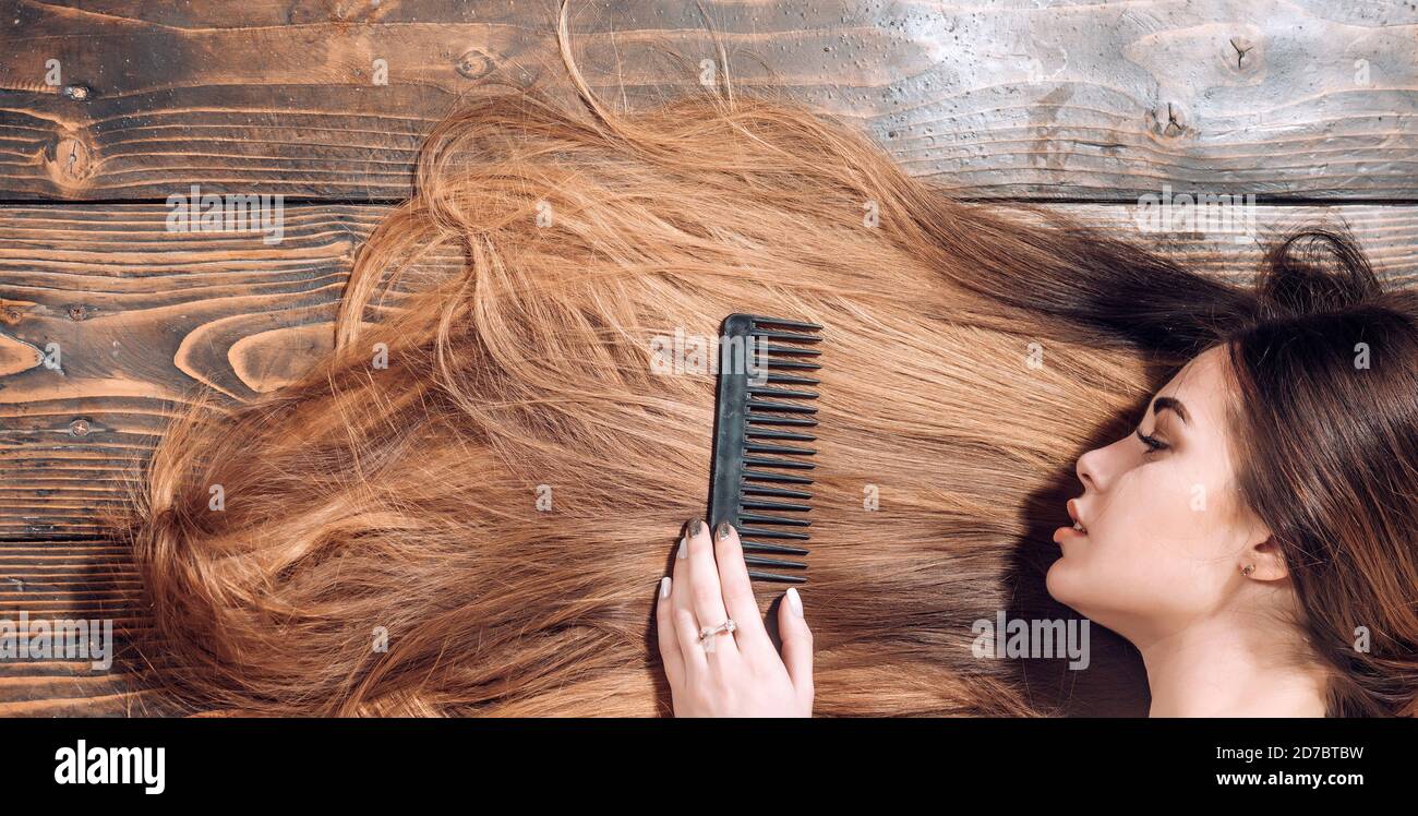 Perfect hair. Blonde brunette long hair. Perfect woman wood background. Beauty and perfect health hair. Beauty model with perfect clean skin and with Stock Photo
