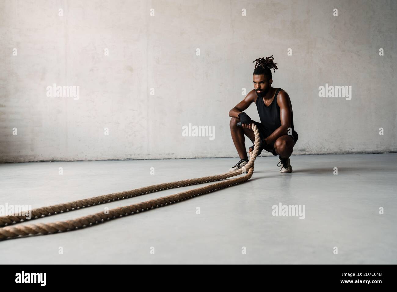 African Boxing Ropes Image of athletic african american sportsman working out with battle ...