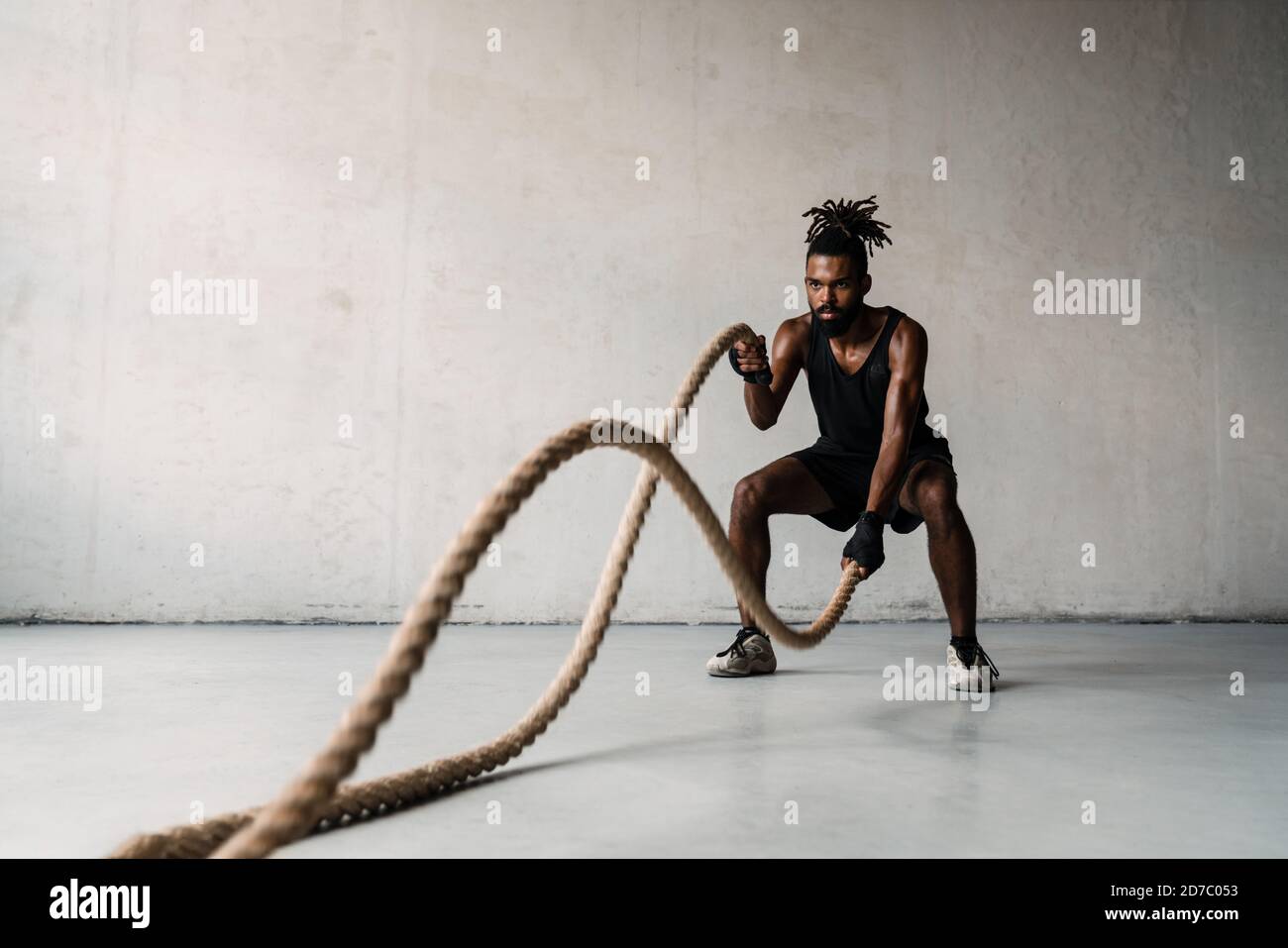 African Boxing Ropes Image of athletic african american sportsman working out with battle ...