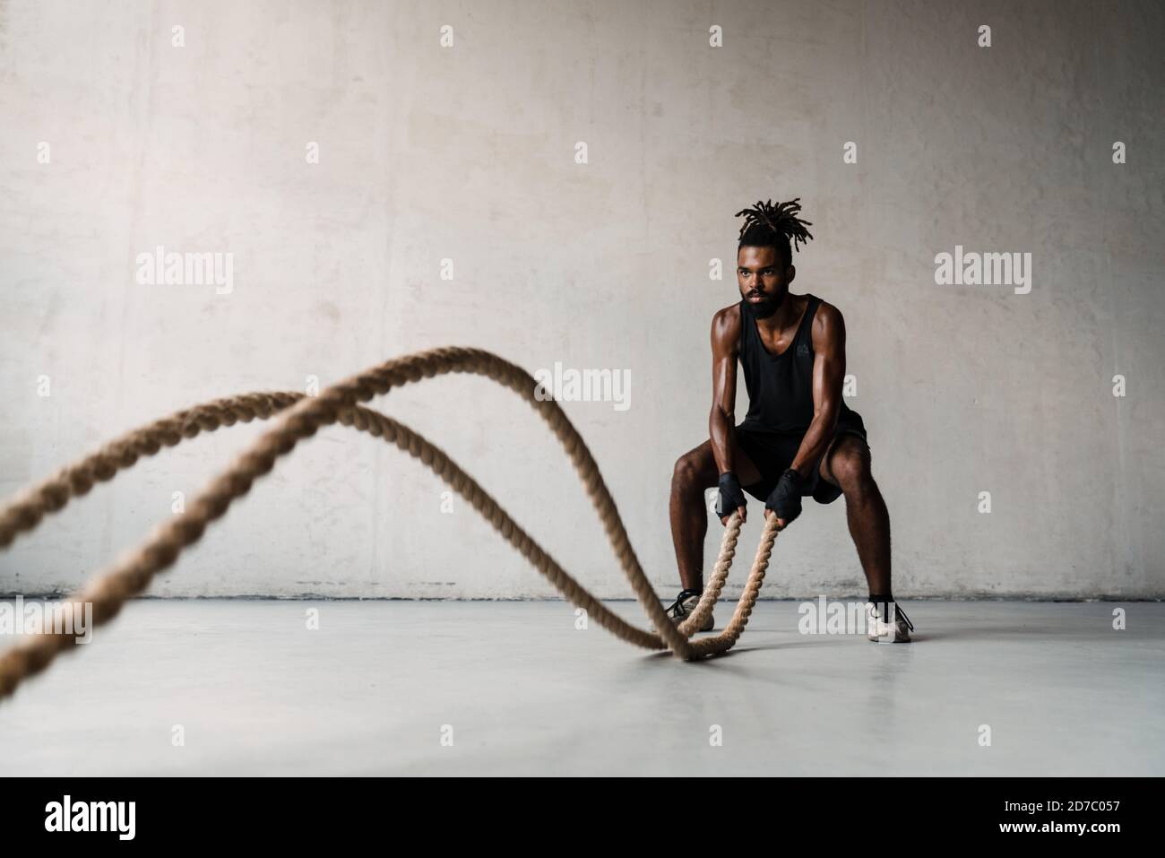 African Boxing Ropes Image of athletic african american sportsman working out with battle ...