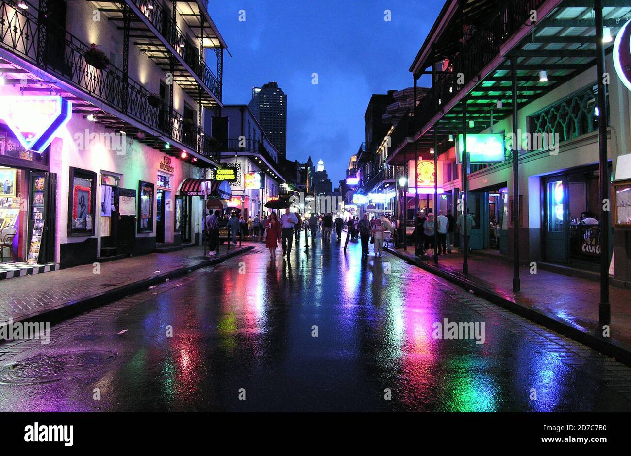 NEW ORLEANS, LOUISIANA, USA - JUNE 5, 2005:  Archival rainy night view of historic Bourbon Street in the French Quarter. Stock Photo