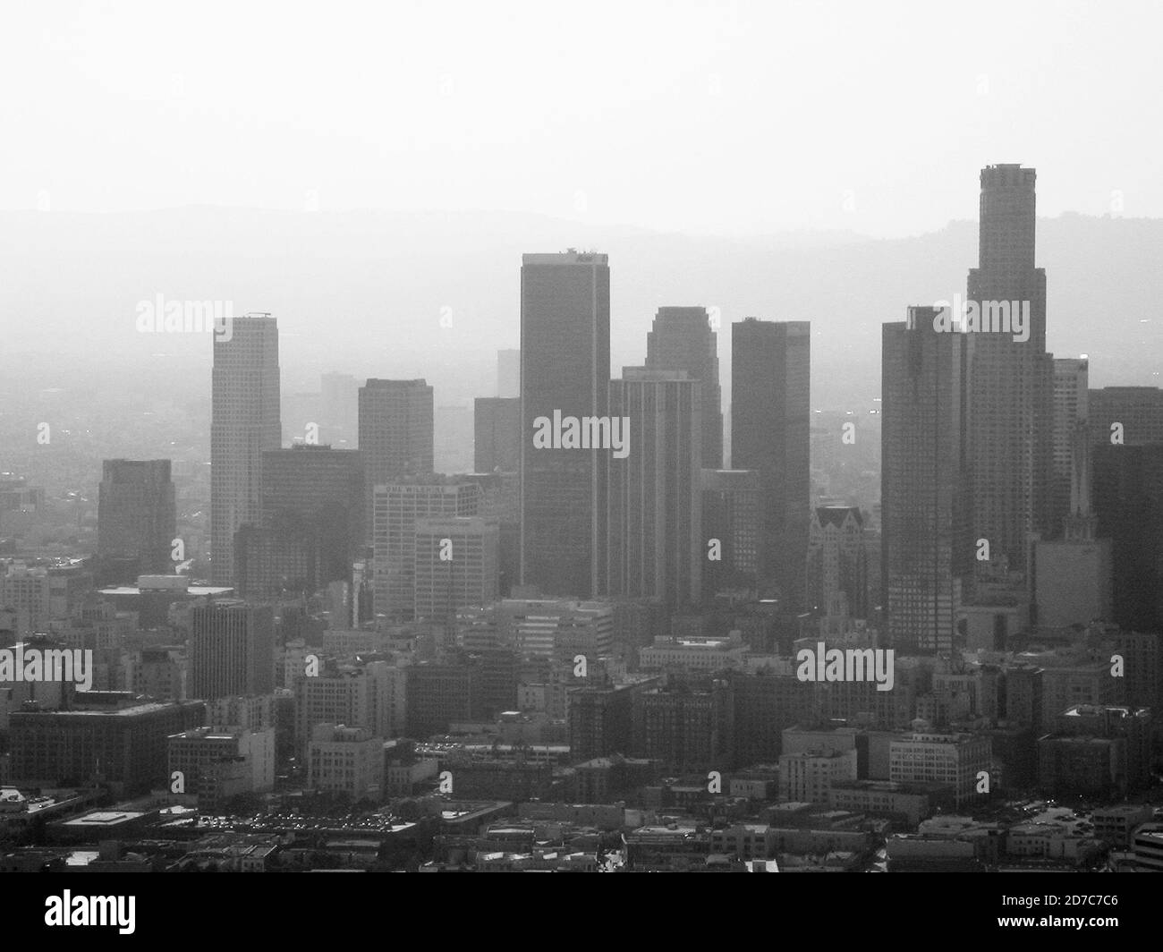 Los Angeles, California, USA - May 2004:  Archival black and white aerial view towers and thick smog in downtown LA. Stock Photo