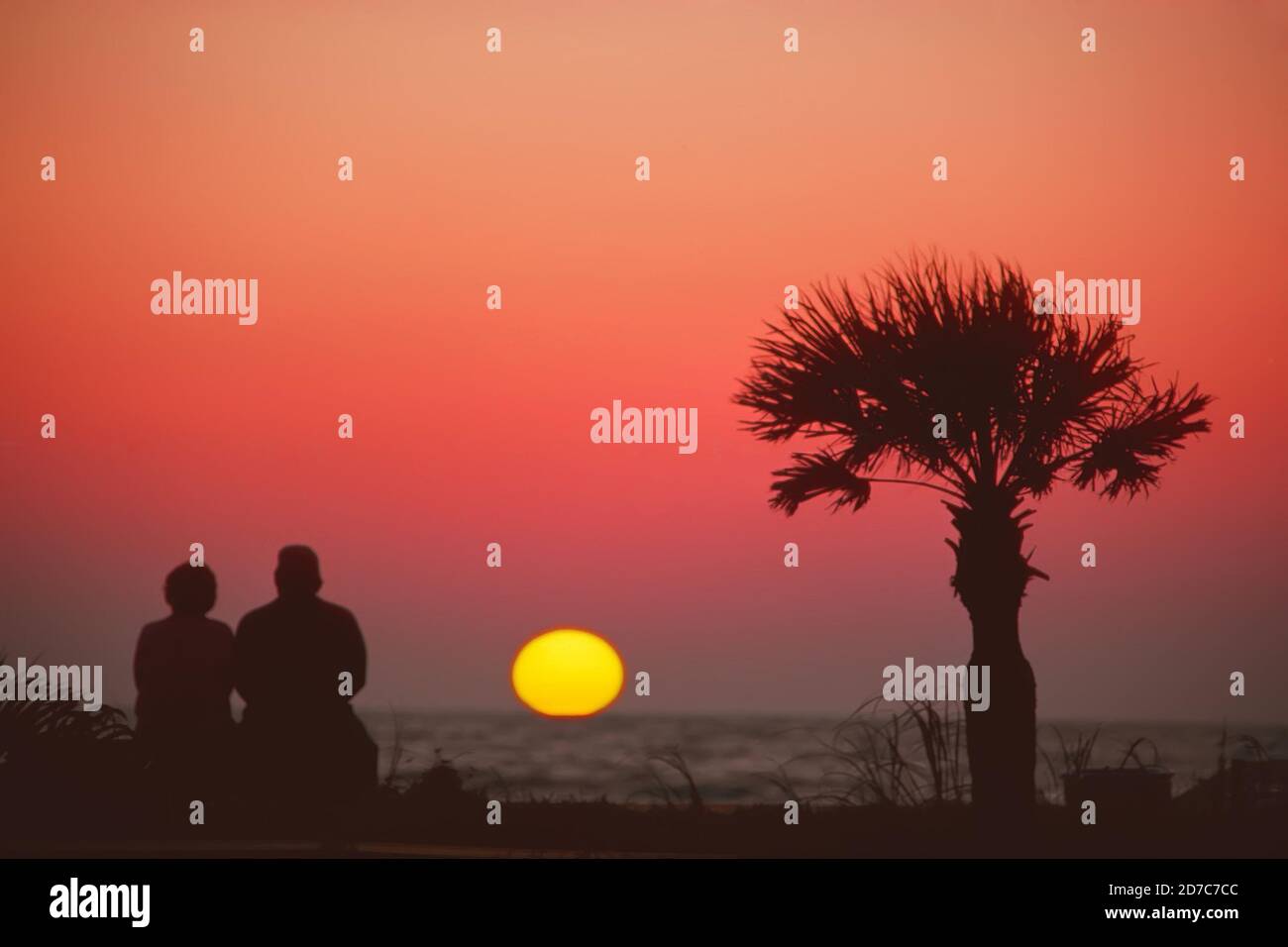 senior couple view sunset together on Naples Beach, Florida Stock Photo