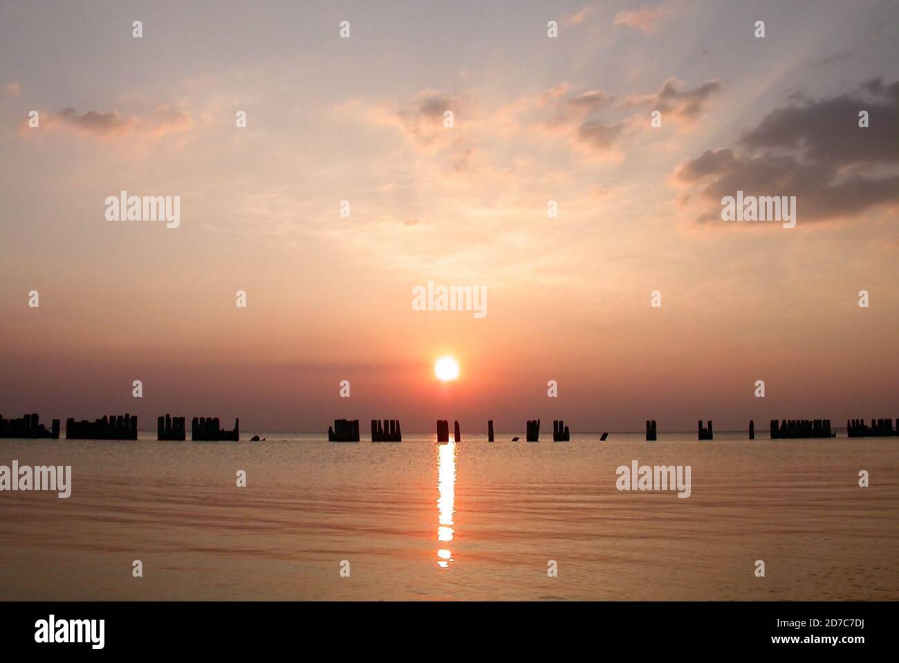 Sunset view of hurricane damaged pier pilings in southern Louisiana USA. Stock Photo