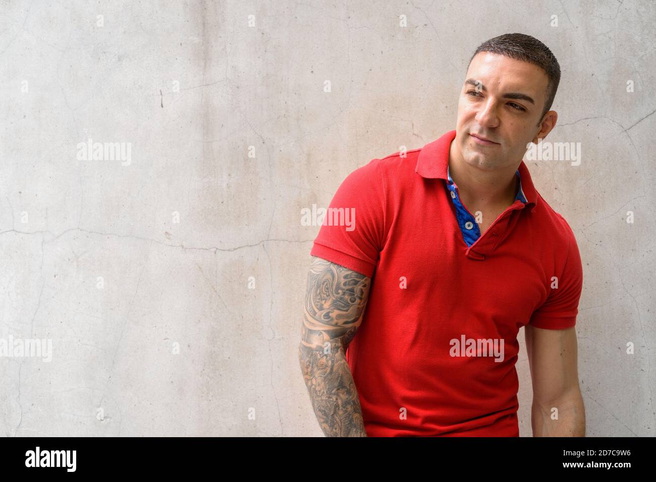 Portrait of handsome man with tattoos thinking outdoors Stock Photo