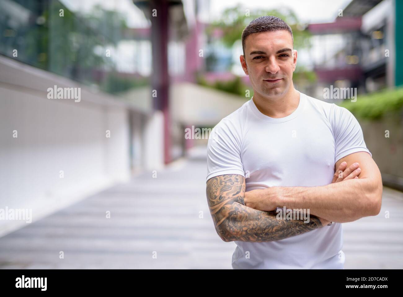 Portrait of handsome man with tattoos in the city outdoors Stock Photo