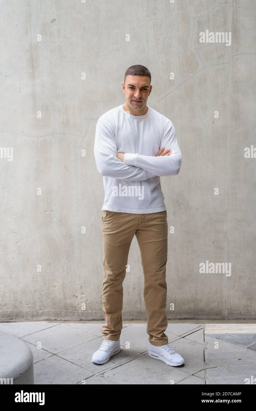 Full body shot of handsome man with arms crossed Stock Photo - Alamy