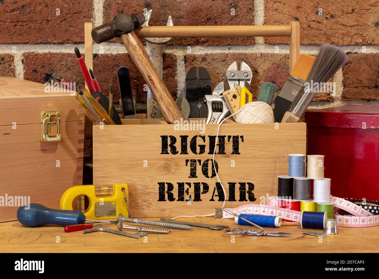 Right to Repair on tool box surrounded by repair tools on bench in cafe used as a repair centre, consumer activism to repair household items to reduce Stock Photo