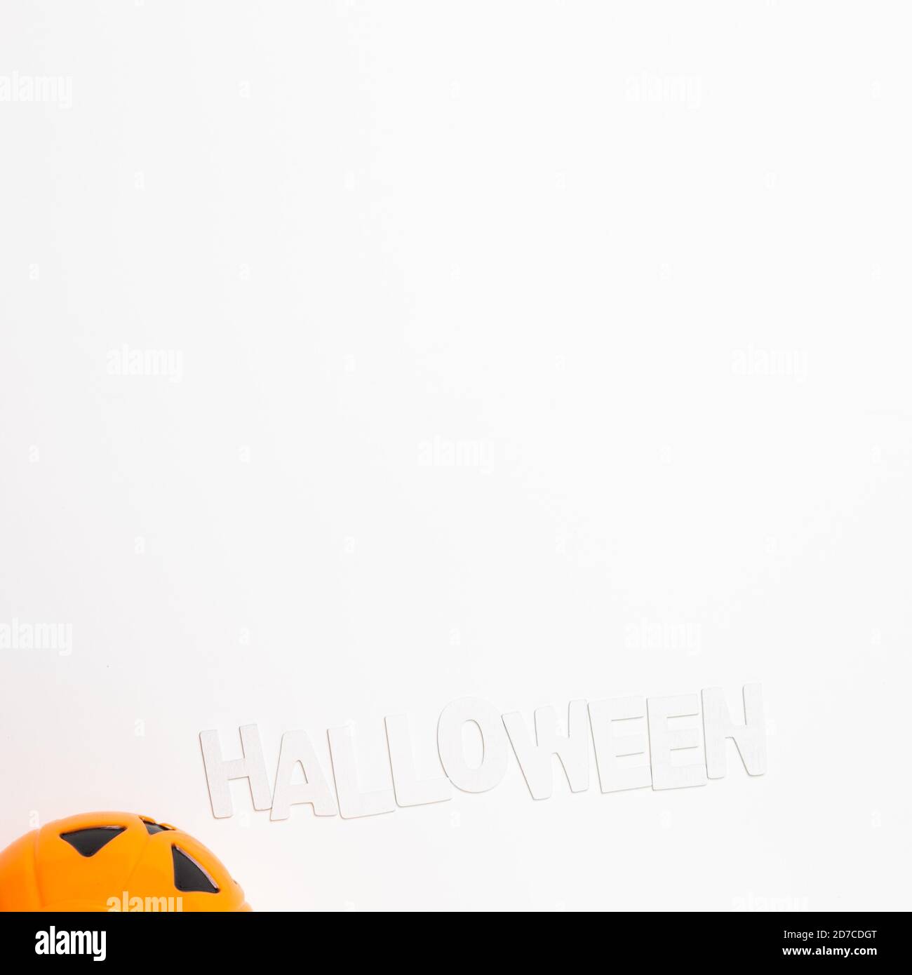 Pumpkin and Halloween text on white background. top view, copy space ...