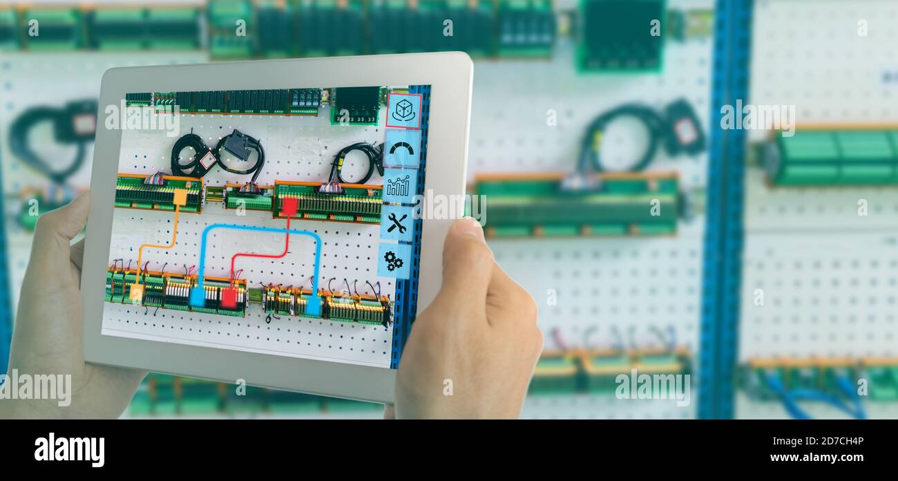 iot smart industry 4.0 concept. Industrial engineer(blurred) using smart glasses with augmented mixed virtual reality technology to read the data that Stock Photo