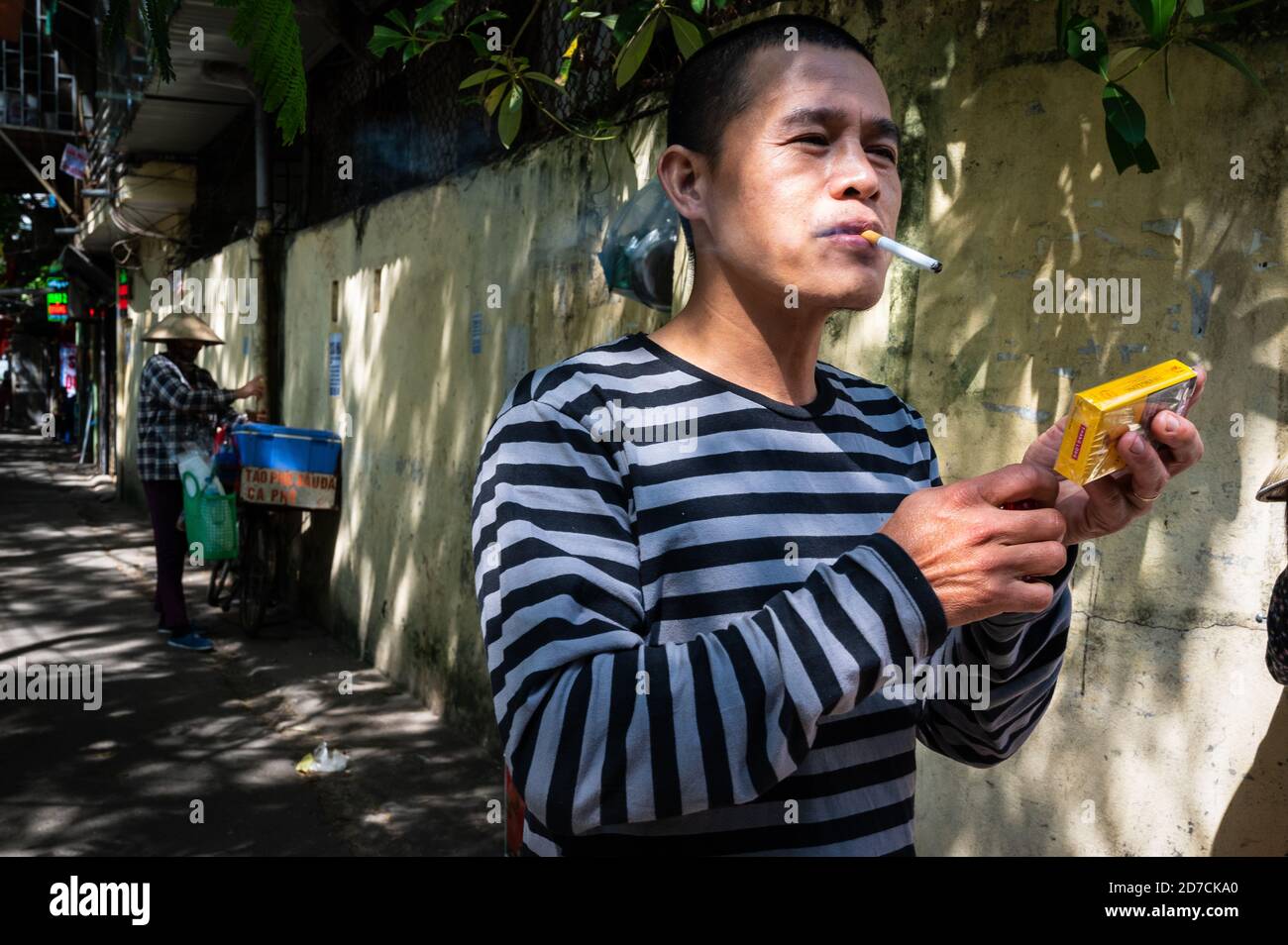 Vietnamese man lighting a cigarette, Hanoi, Vietnam Stock Photo Alamy