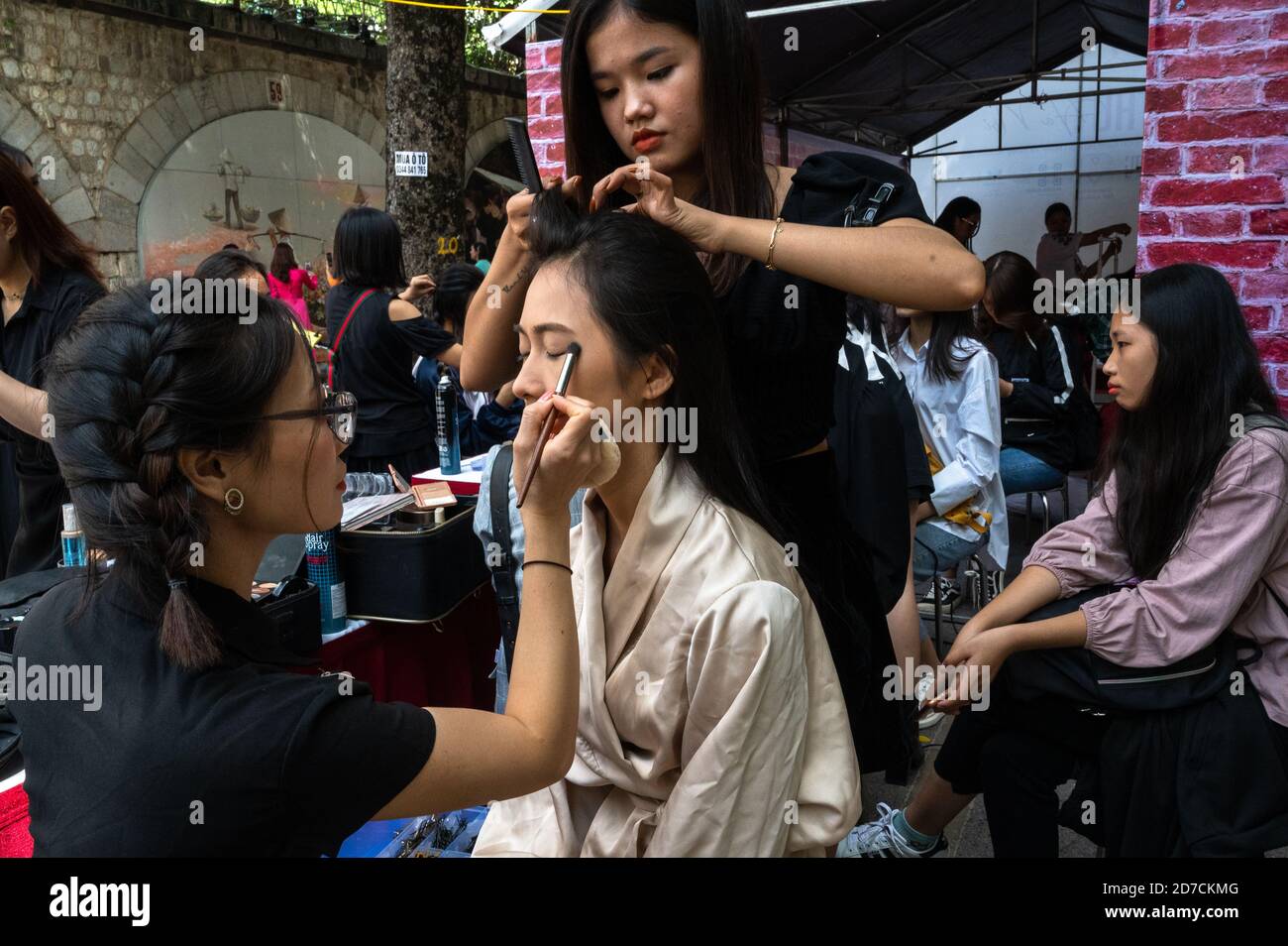 Young women getting made up for a modeling event, Pho Bich Hoa Phung Hung, Hanoi, Vietnam Stock Photo