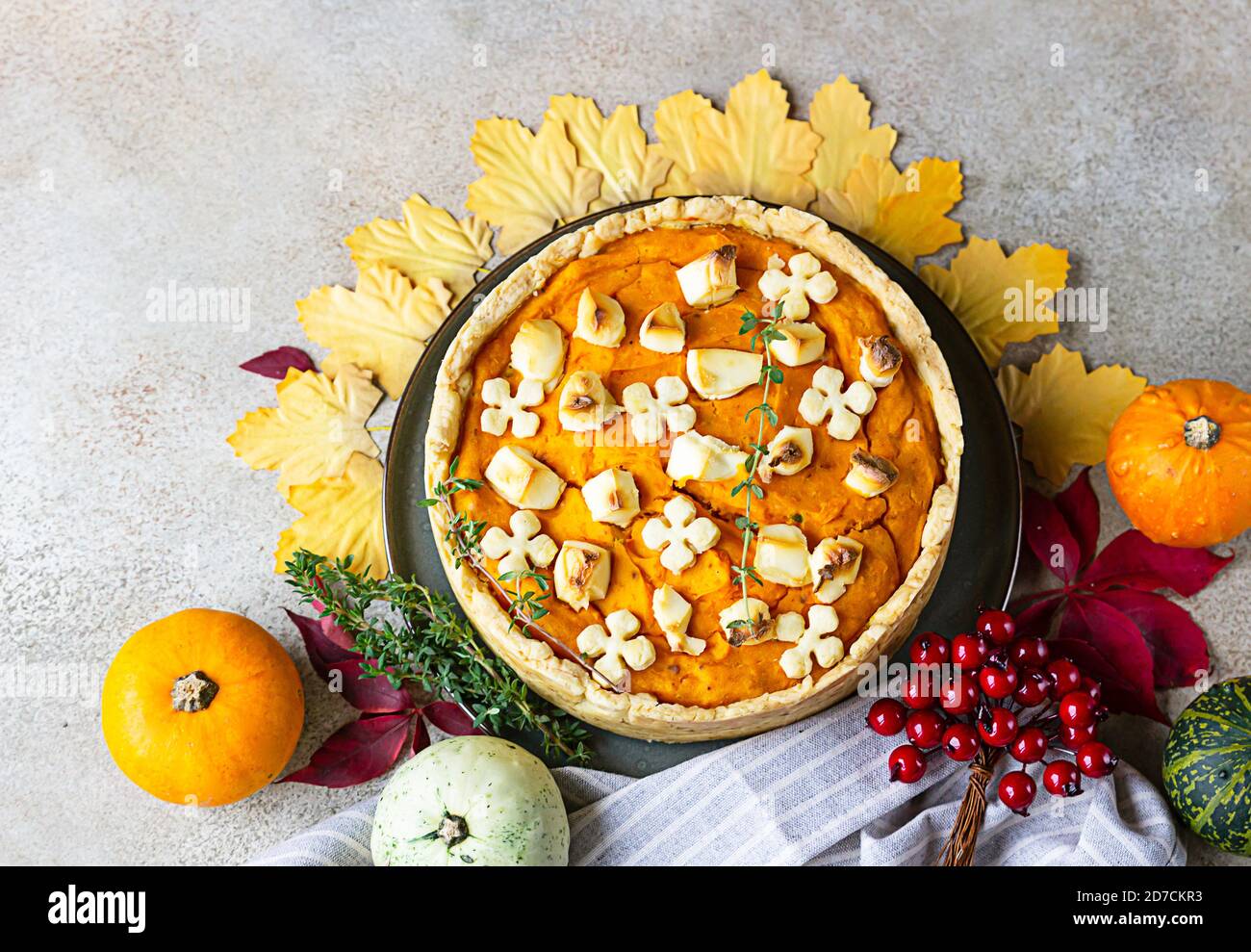 Top view of pumpkin tart or pie with feta cheese and thyme. Fall season concept. Cozy autumn food background. Stock Photo