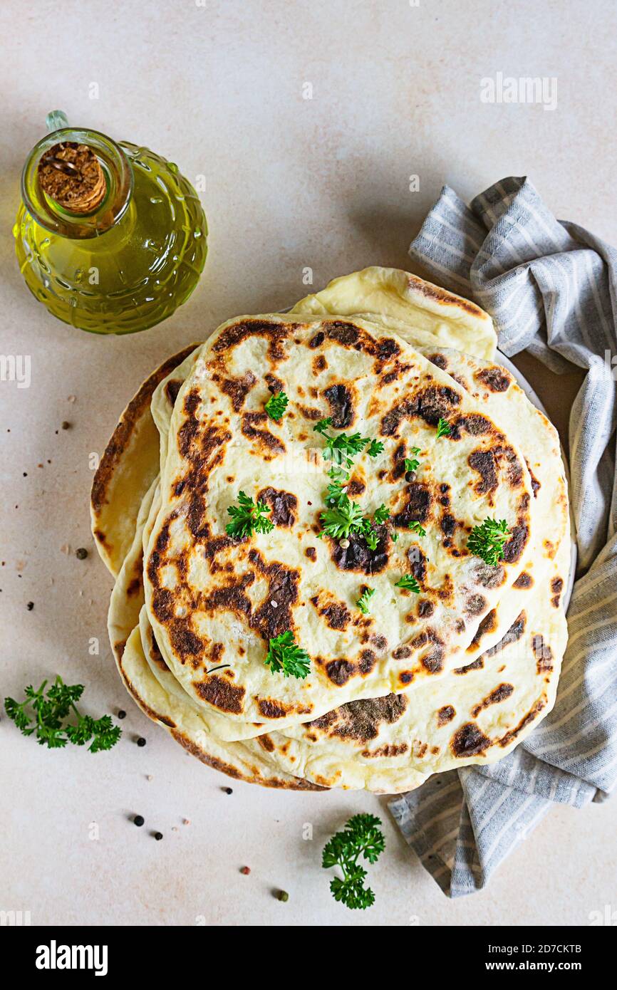 Indian homemade traditional flatbread with fresh parsley and olive oil