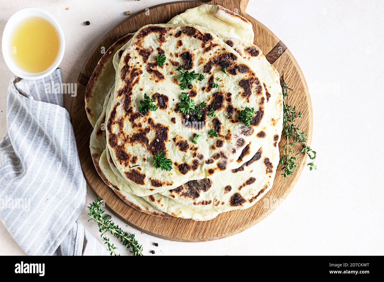Indian homemade traditional flatbread with fresh parsley and olive oil