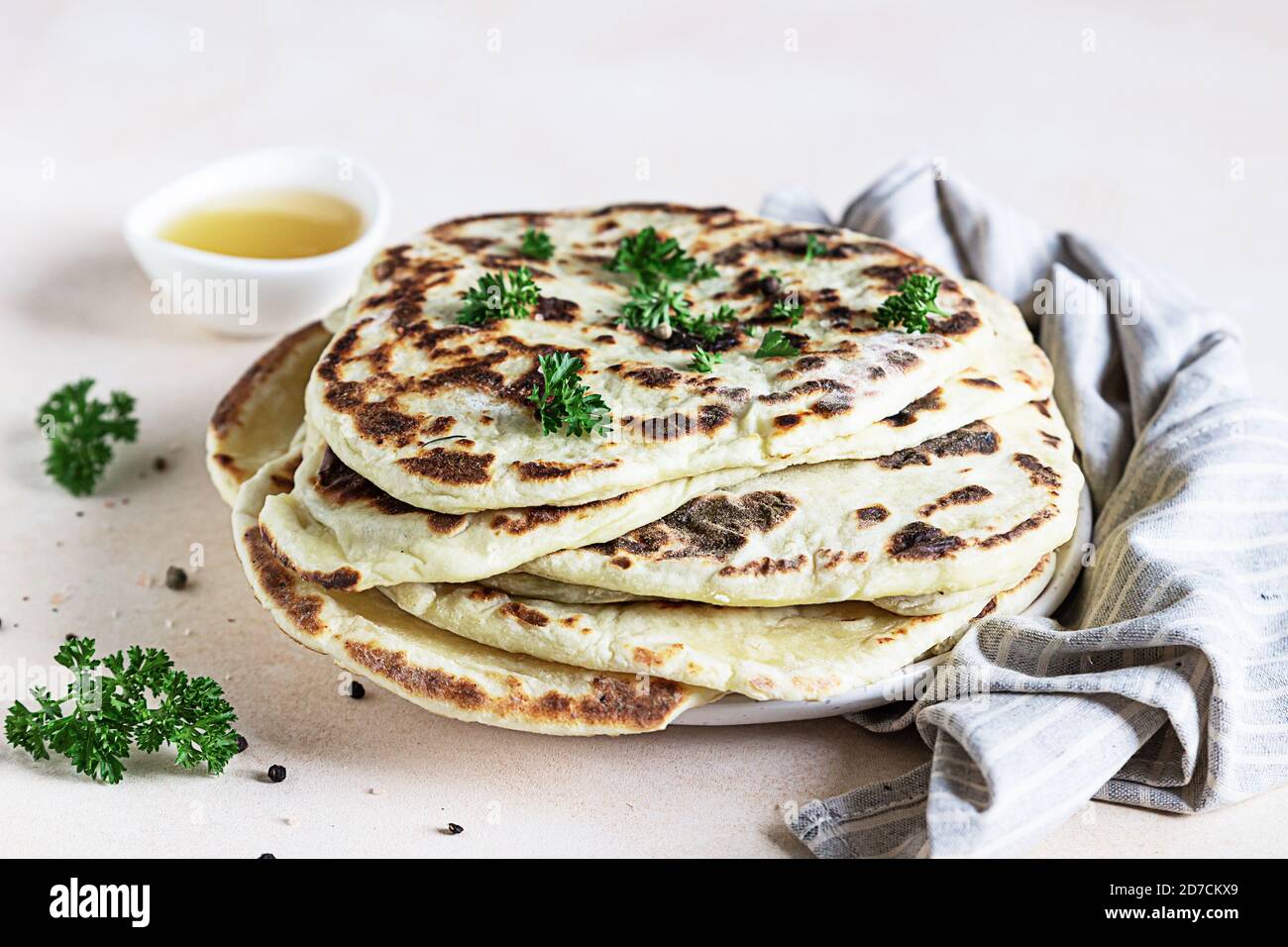 Indian homemade traditional flatbread with fresh parsley and olive oil