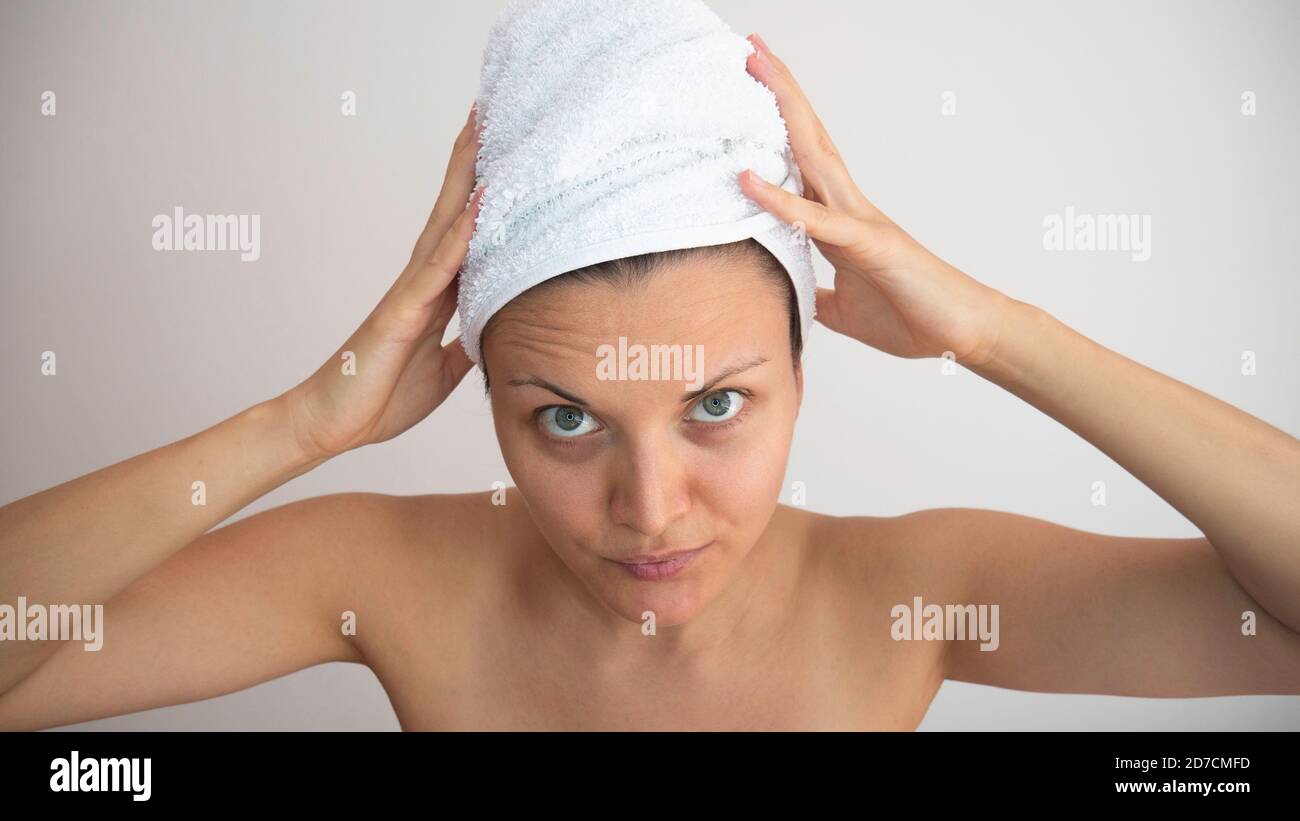 The woman wrapped her wet hair in a white towel Stock Photo Alamy