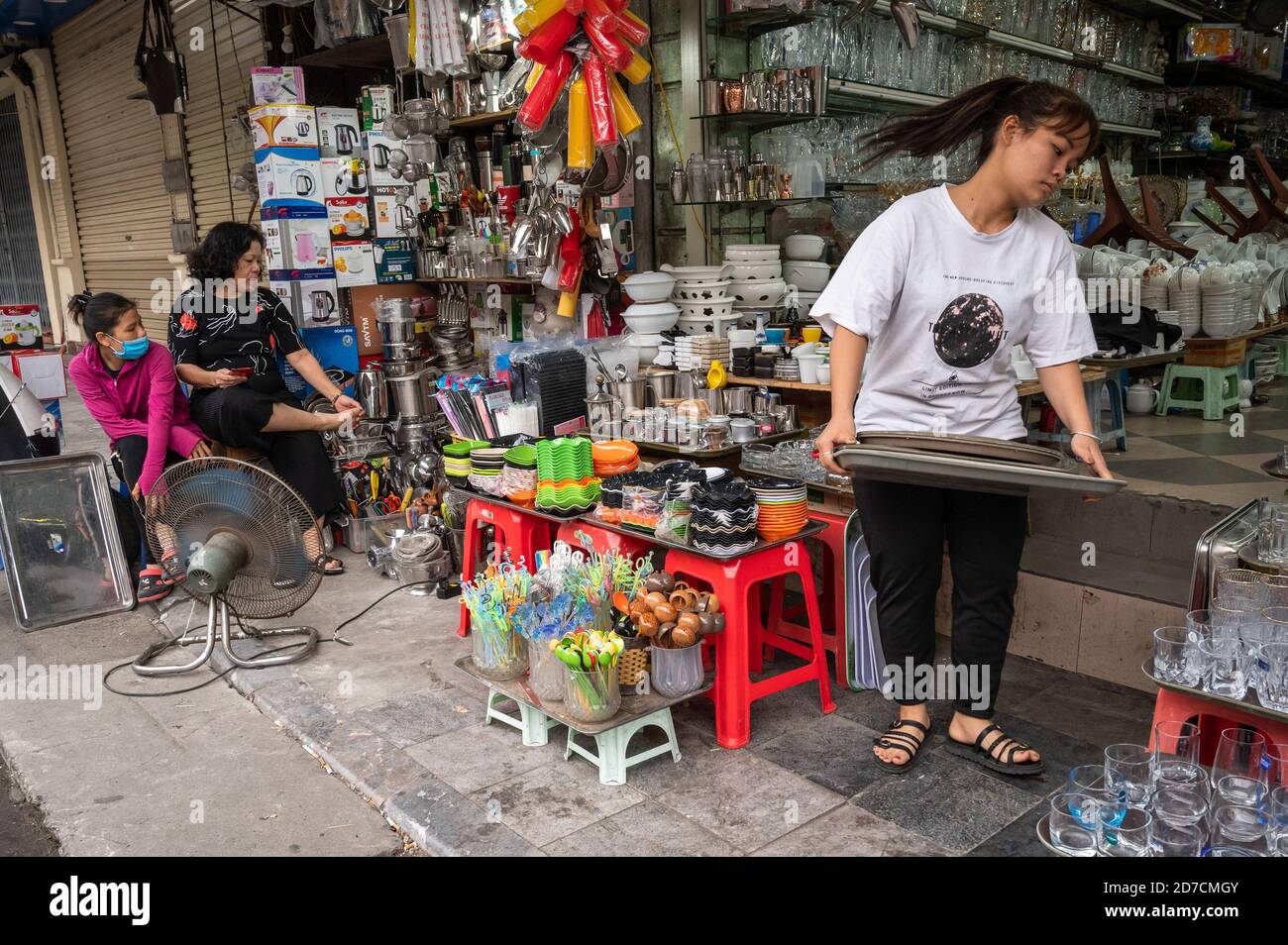 A woman setting up shop, Hanoi, Vietnam Stock Photo